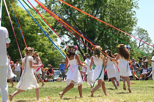 Students participate in a May Day celebration